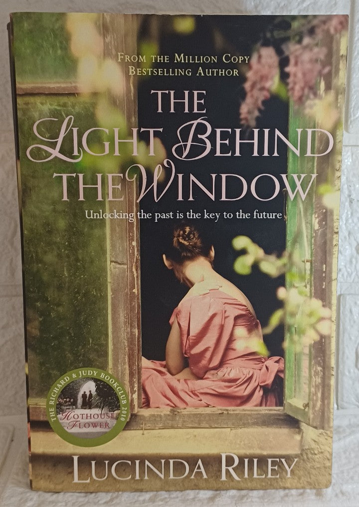 Front Cover Of The Light Behind the Window (Lucinda Riley)