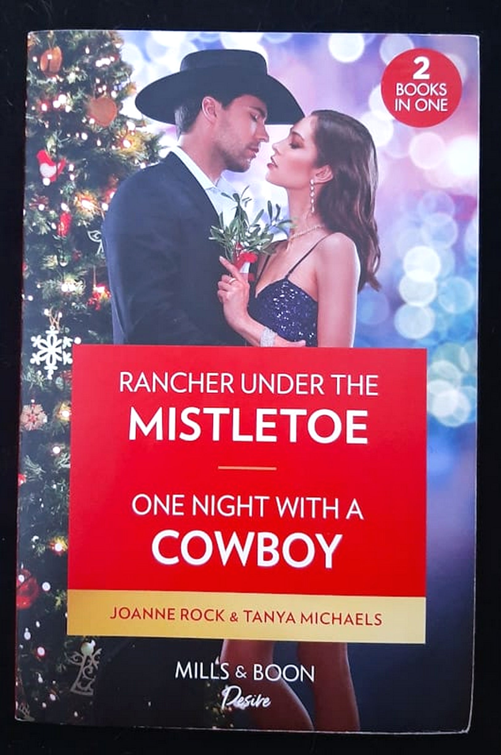 Front Cover Of Rancher Under The Mistletoe / One Night With A Cowboy (Joanne Rock and Tanya Michaels)