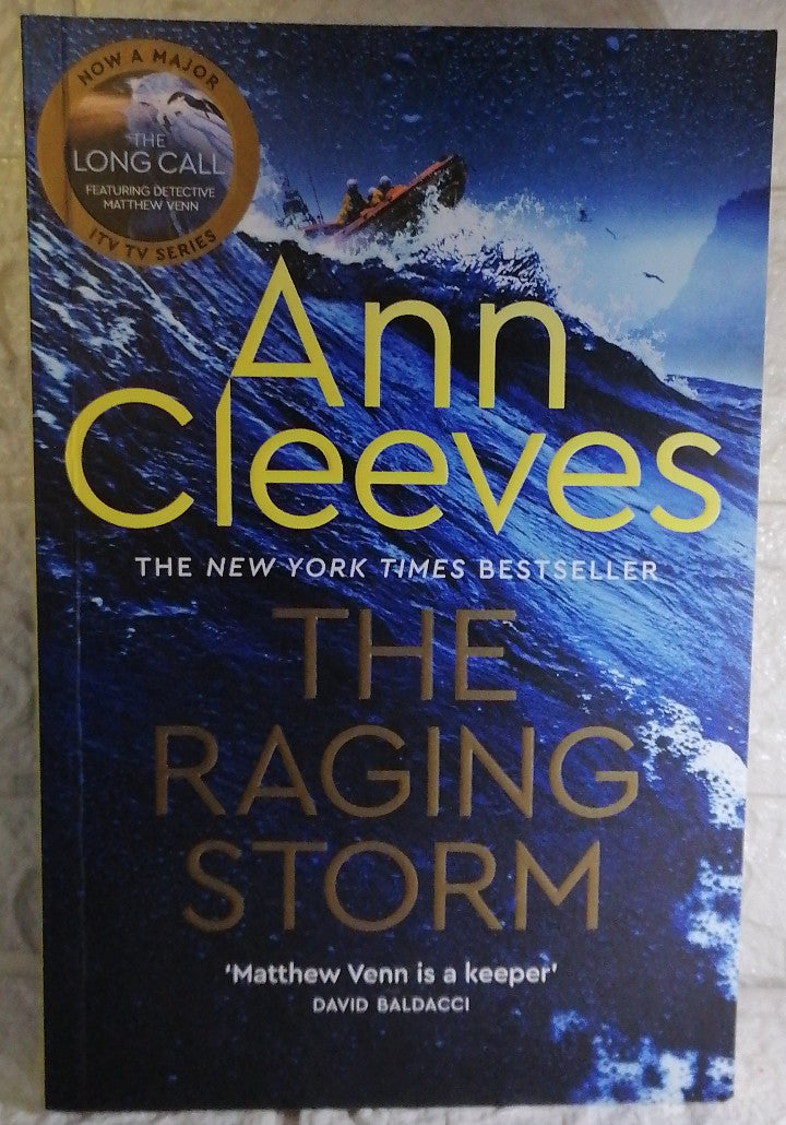 Front Cover Of The Raging Storm (Two Rivers #3) (Ann Cleeves)