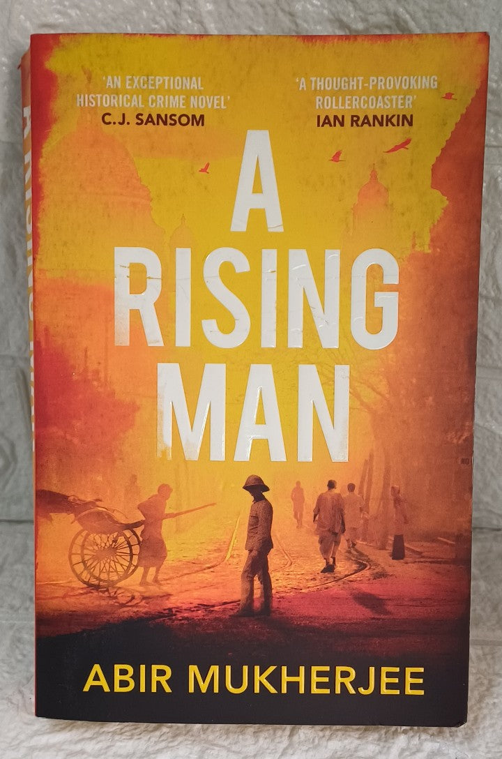 Front Cover Of A Rising Man (Sam Wyndham, #1) (Abir Mukherjee)