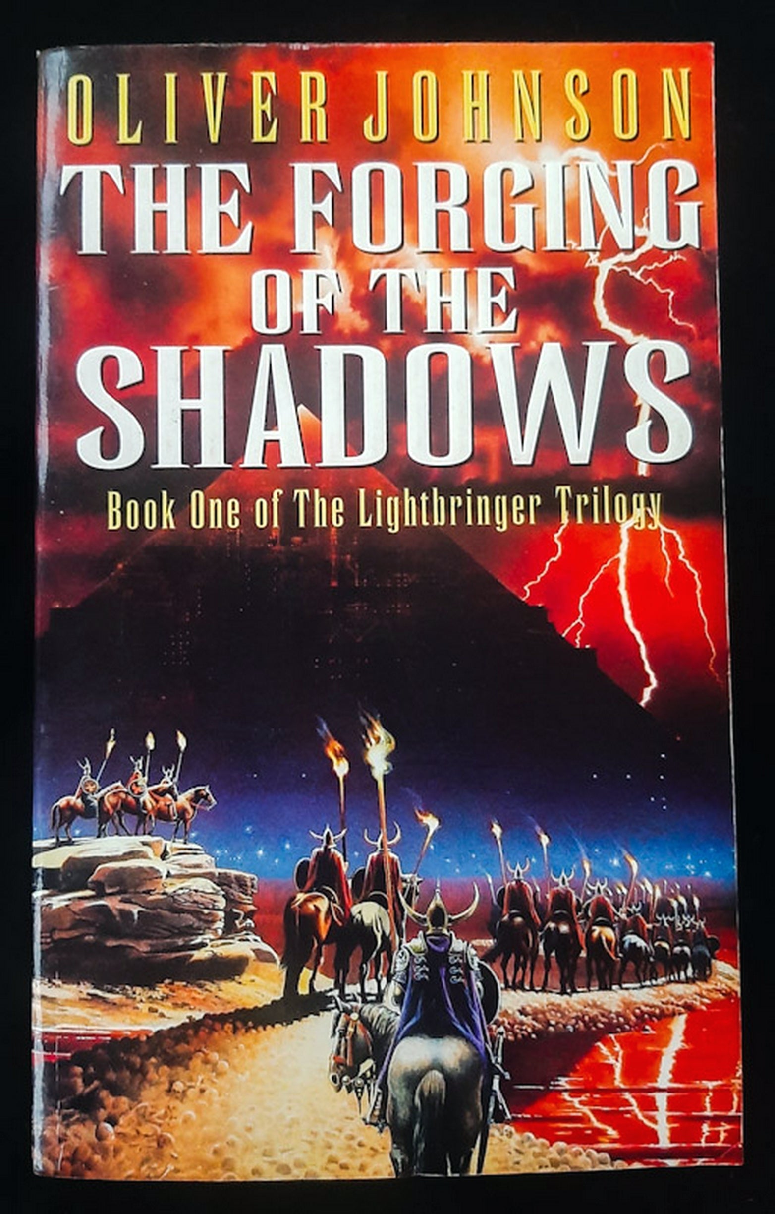 Front Cover Of The Forging Of The Shadows (The Lightbringer #1) (Oliver Johnson)