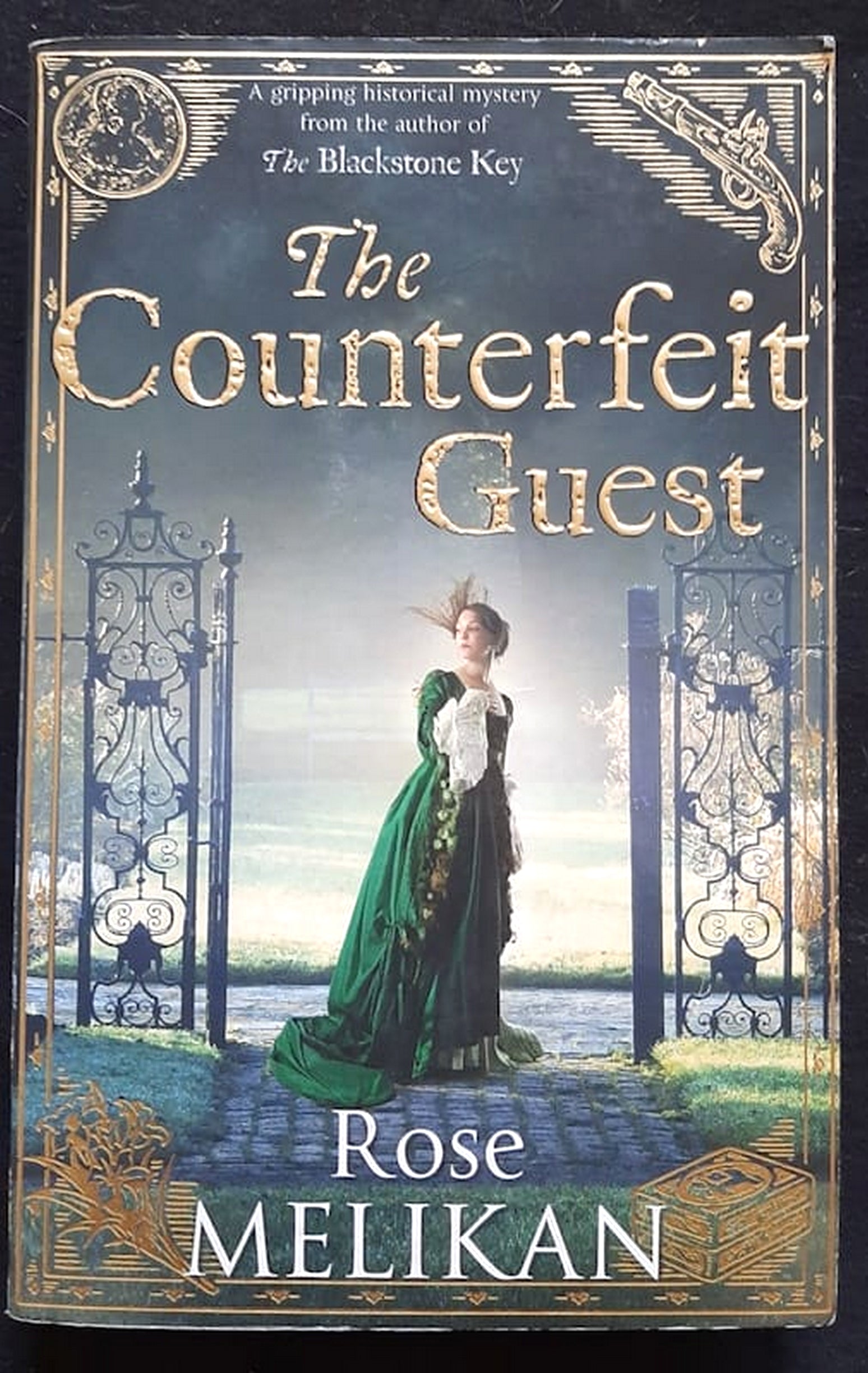 Front Cover Of Bestselling Book The Counterfeit Guest (Mary Finch #2) (Rose Melikan
)