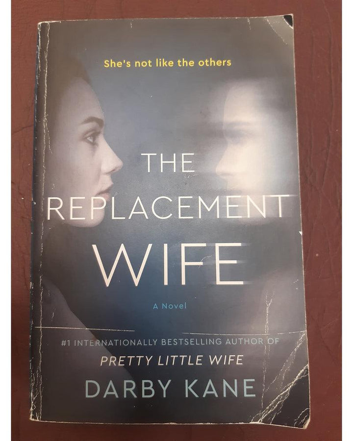 Front Cover Of The Replacement Wife: A Novel (Darby Kane))